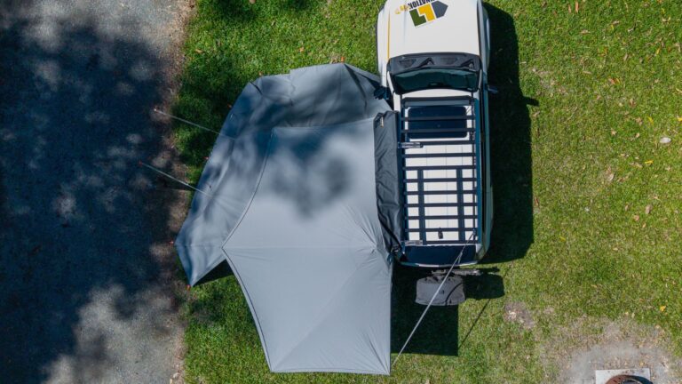 Destination4wd freestanding awning with walls top view showcasing white Toyota Prado and grey canvas awning