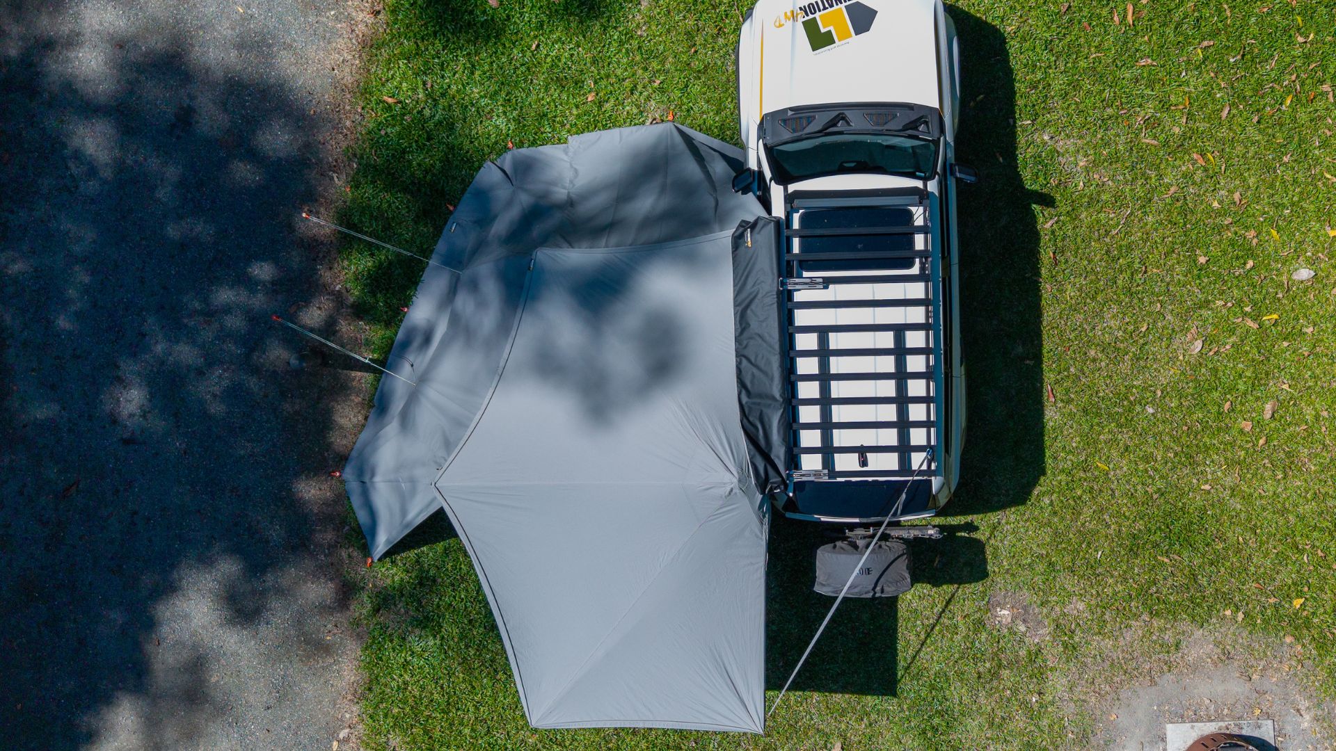 Destination4wd freestanding awning with walls top view showcasing white Toyota Prado and grey canvas awning