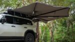 Destination4wd freestanding awning with walls top view showcasing white Toyota Prado and grey canvas awning